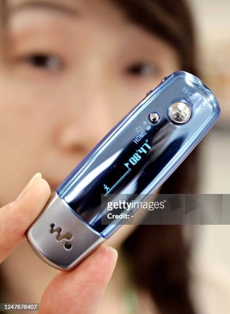 Sony employee Saori Takahashi displays the new digital audio player "Walkman E-series", equipped with a 2GB, 1GB or 512MB flash memory on the...