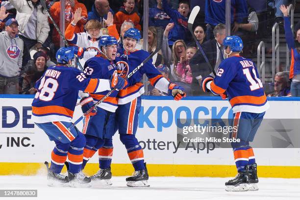 Casey Cizikas of the New York Islanders is congratulated by his teammates after scoring a goal against the Buffalo Sabres during the second period at...