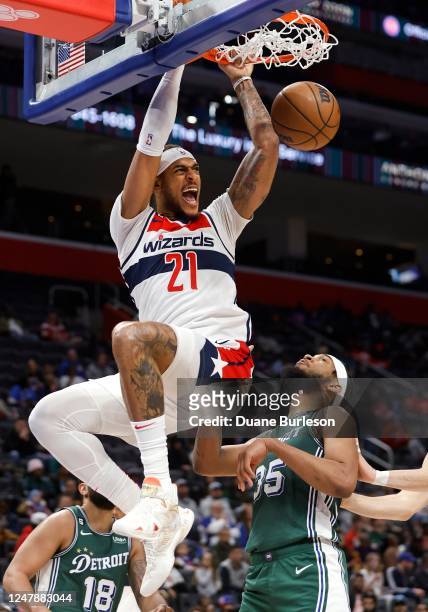 Daniel Gafford of the Washington Wizards dunks over Marvin Bagley III of the Detroit Pistons during the second half at Little Caesars Arena on March...