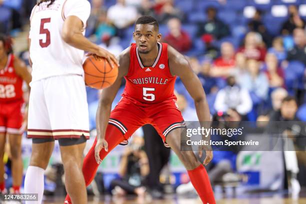 Brandon Huntley-Hatfield of the Louisville Cardinals defends DeMarr Langford Jr. Of the Boston College Eagles as he brings the ball down the court...