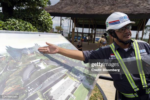 Worker shows an artist rendition of the country's new capital Nusantara, known as IKN, during a media tour in Penajam Paser Utara, East Kalimantan...