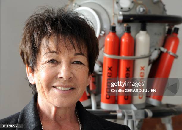 French managing director of Comex, a company specializing in engineering and deep diving operations, Michèle Fructus, poses in front of a model of a...