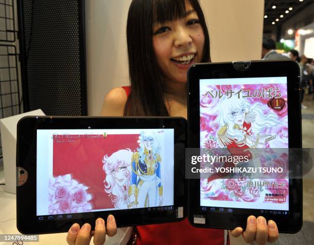 Model displays Japanese electronics giant Toshiba's tablet PC "Regza Tablet AT300" as an book reader, equipped with NVIDIA's Tegra2 processor on its...