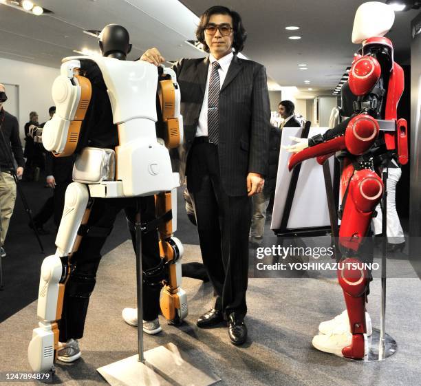 Japan's robot suit venture Cyberdyne president and Tsukuba University professor Yoshiyuki Sankai displays the full-body type HAL robotic exoskeleton...