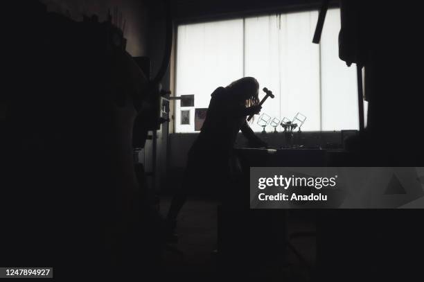 Andrea Kosec works on pieces of hot iron rods inside her workshop, located on their farm ahead of the International Women's Day in Hajnacka,...