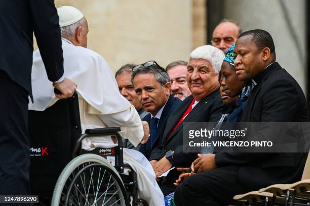 Pope Francis arrives in a wheelchair to bless two young Nigerian women, Janada Marcus and Mariamu Joseph , victims of Islamist group Boko Haram,...