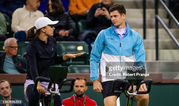 Iga Swiatek of Poland talks to Hubert Hurkacz of Poland during the Eisenhower Cup on Day 2 of the 2023 BNP Paribas Open at the Indian Wells Tennis...