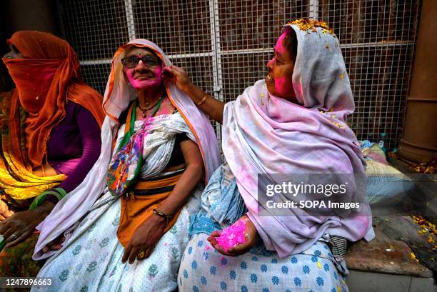 Indian Widows put colorful powders on each other during a celebration of Holi or 'festival of colors' at Gopinath Temple in Vrindavan. Indian widows,...