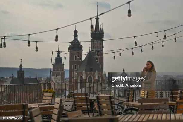 Sylwia Pieczara, a journalist at TVP Krakow on the phone during a coffee break at the METRUM Restobistro, on March 7 in Krakow, Poland. Even on rare...