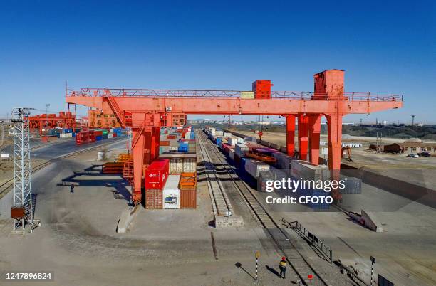 Machinery and equipment load and unload containers at Erenhot railway port in Xilin Gol League, Inner Mongolia, China, March 8, 2023. The number of...