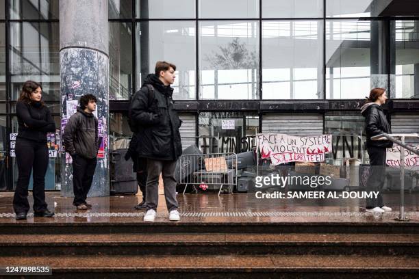 Students stand outside Lille's university campus during a blockade as part of the movement against the government's proposed pensions reform and in...