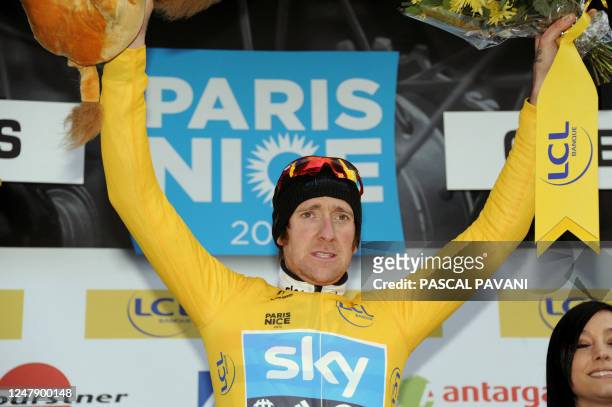 Britain's Bradley Wiggins celebrates his Yellow jersey of overall leader on the podium on March 05, 2012 at the end of the 185,5 km and second stage...