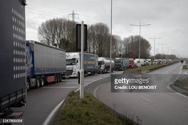 Trucks queue as unionists block the accesses to the port of Le Havre, Normandy, on March 8, 2023 during a day of action also affected the ports of...