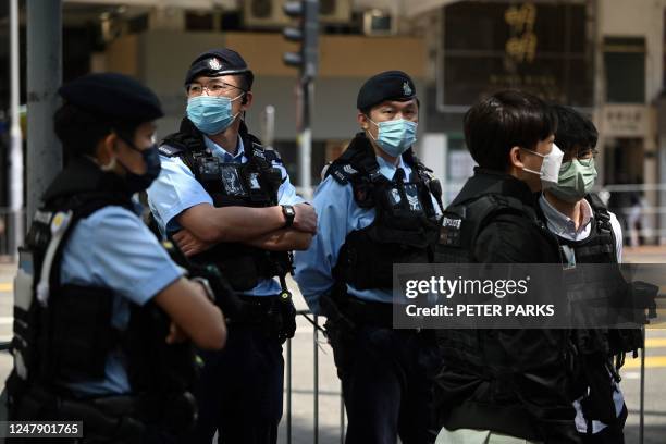 This photo taken on March 5, 2023 shows police keeping watch on a street in the Wanchai district of Hong Kong, after the Hong Kong Women Workers'...