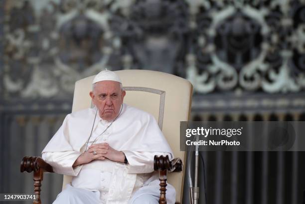 Pope Francis sits as he attends the weekly general audience in St. Peter's Square at The Vatican, Wednesday, March 8, 2023.