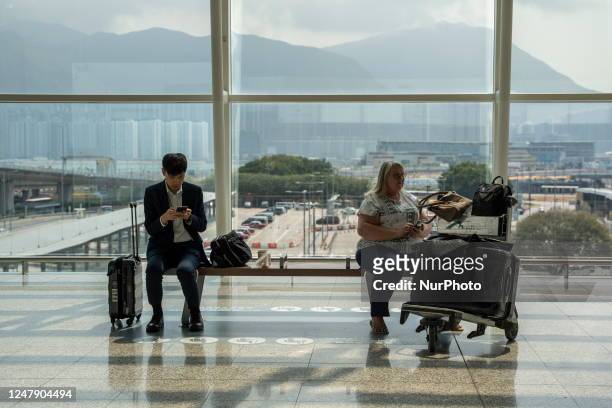 Travelers with luggage at Hong Kong International Airport on March 8, 2023 in Hong Kong, China. Today the Hong Kong Based Airline Carrier Announced...