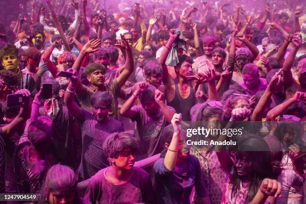 Revellers daubed in Gulal or coloured powder dance as they celebrate Holi Festival on March 8, 2023 in Guwahati, India. Holi is the Hindu festival of...