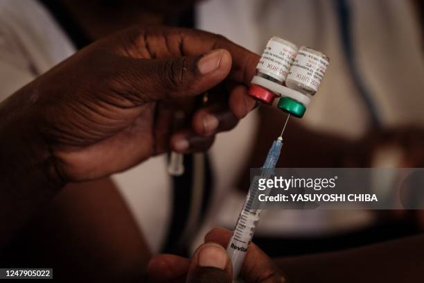 Nurse prepares a shot during the launch of the extension of the worlds first malaria vaccine pilot program for children at risk of malaria illness...
