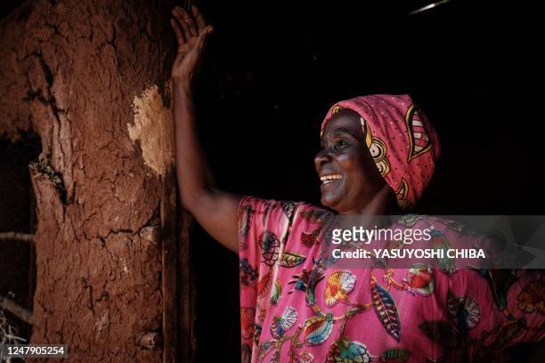 Ruth Kavere reacts before her granddaughter Faith who completed doses through the worlds first malaria vaccine pilot program, returns from her...