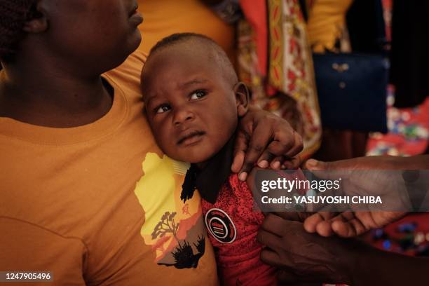 Child receives a shot during the launch of the extension of the worlds first malaria vaccine pilot program for children at risk of malaria illness...