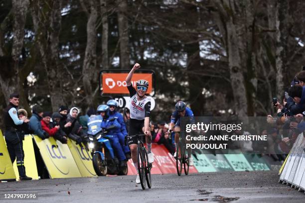 Team Emirates' Slovenian rider Tadej Pogacar gestures to celebrate as he crosses the finish line in front of Groupama-FDJ's French rider David Gaudu...