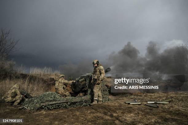 Ukrainian servicemen fire with a 105mm howitzer towards Russian positions near the city of Bakhmut, on March 8 amid the Russian invasion of Ukraine.