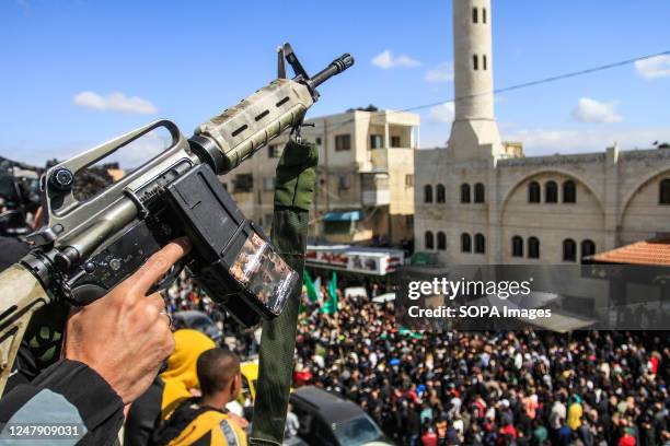 Palestinian gunman shoots in the air at the funeral of Abdul Fattah Kharushah in the West Bank city of Nablus. The Israeli army raided the occupied...