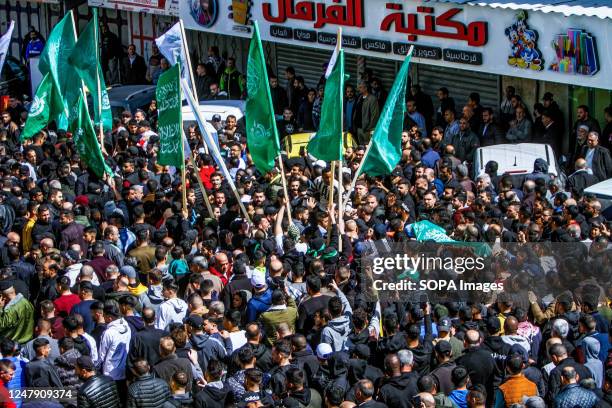 Mourners wave Hamas flags while chanting slogans at the funeral of Abdul Fattah Kharushah in the West Bank city of Nablus. The Israeli army raided...