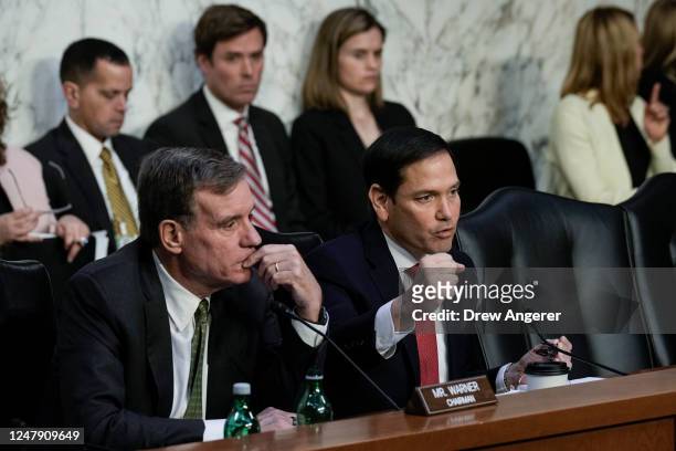 Committee chairman Sen. Mark Warner looks on as ranking member Sen. Marco Rubio questions witnesses during a Senate Intelligence Committee hearing...