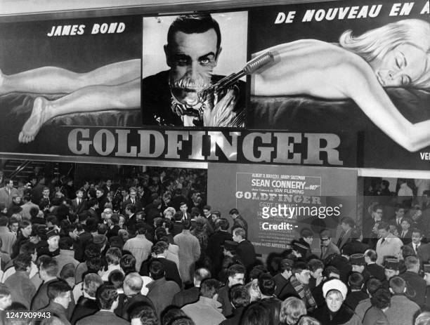 Photo taken on February 18, 1965 shows people wating to see "Goldfinger", starring Sean Connery as the fictional MI6 agent James Bond, during the...