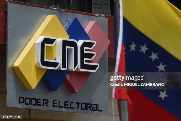 Picture of the logo of the National Electoral Council on the facade of its headquarters in Caracas and a Venezuelan national flag, taken on March 8,...