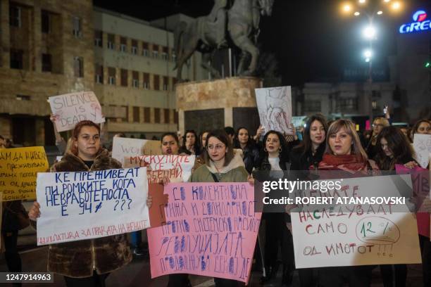 Women hold a placards during a rally to mark the International Women's Day in Skopje on March 8, 2023.