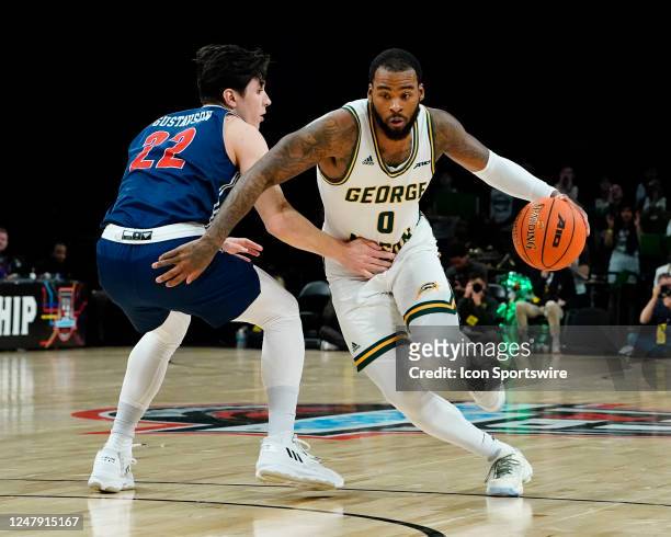 George Mason Patriots Guard DeVon Cooper dribbles the ball against Richmond Spiders Guard Andre Gustavson during the first half of the Atlantic 10...