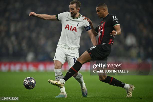 Tottenham Hotspur's English striker Harry Kane fights for the ball with AC Milan's German-Finnish defender Malick Thiaw during the UEFA Champions...