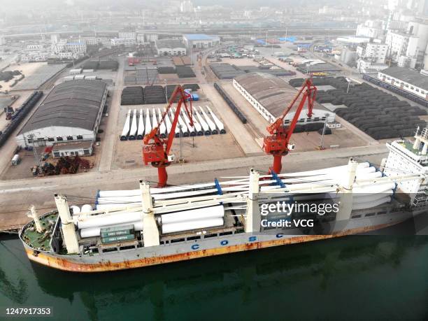 Aerial view of wind turbine blades which will be shipped abroad sitting stacked at a container ship berthed at Lianyungang Port on June 6, 2020 in...