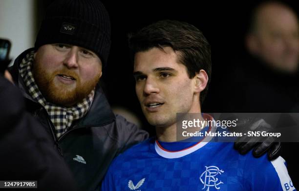 Rangers fan gets a photo with Ianis Hagi during a cinch Premiership match between Hibernian and Rangers at Easter Road, on March 08 in Edinburgh,...