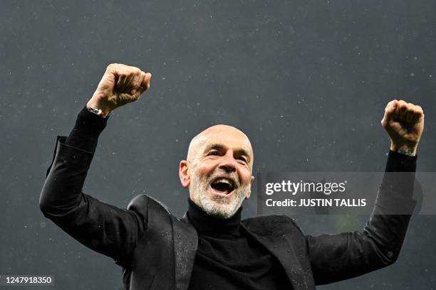 Milan's Italian coach Stefano Pioli celebrates at the end of the UEFA Champions League round of 16 second-leg football match between Tottenham...