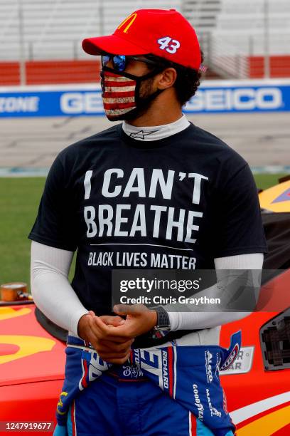 Bubba Wallace, driver of the McDonald's Chevrolet, wears a "I Can't Breathe - Black Lives Matter" T-shirt under his fire suit in solidarity with...
