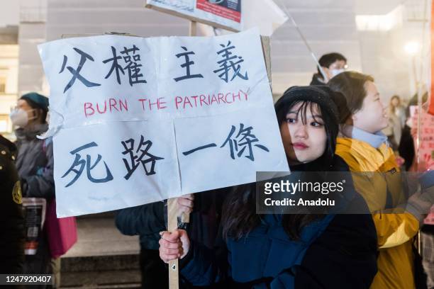 Women holds a placard in Trafalgar Square during an international protest against violence towards women, institutional misogyny in the police,...