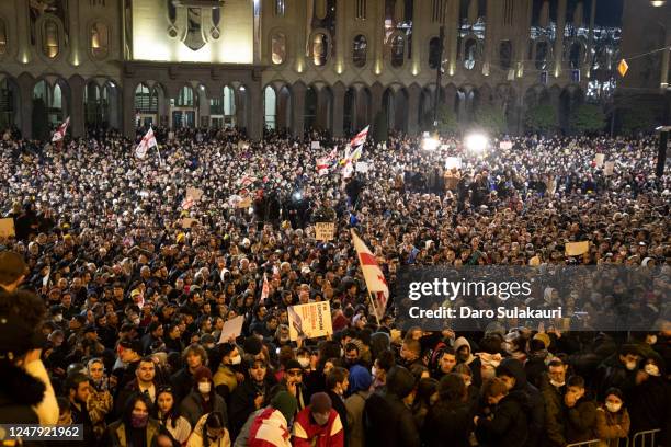 Thousands of people gather in front of the parliament to protest on March 8, 2023 in Tbilisi, Georgia. Thousands of protestors with EU and national...