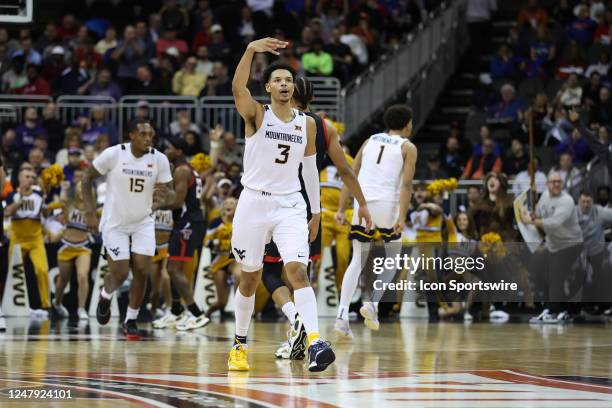 West Virginia Mountaineers forward Tre Mitchell celebrates making a three in the second half of a Big 12 Tournament basketball game between the Texas...