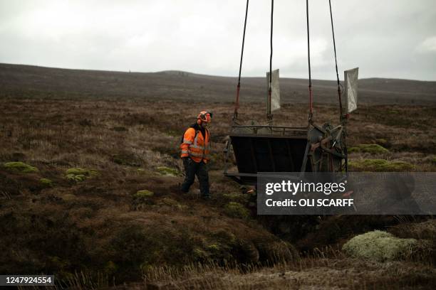 Robert Gait, a Site Manager of Conservefor, a rural conservation and recreation specialist contractor, works to create stone dams to aid peatland...