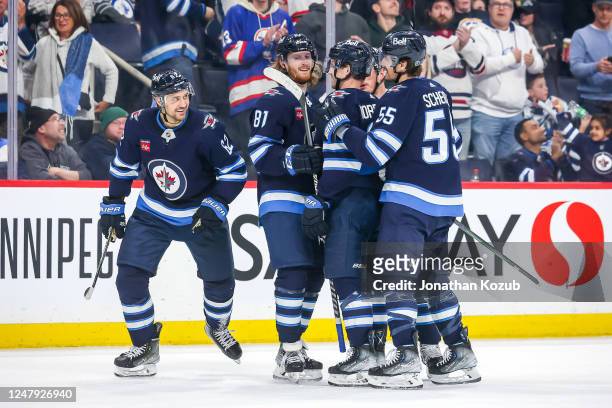 Nino Niederreiter of the Winnipeg Jets celebrates his second period goal against the Minnesota Wild with teammates Kyle Connor, Josh Morrissey, Nate...