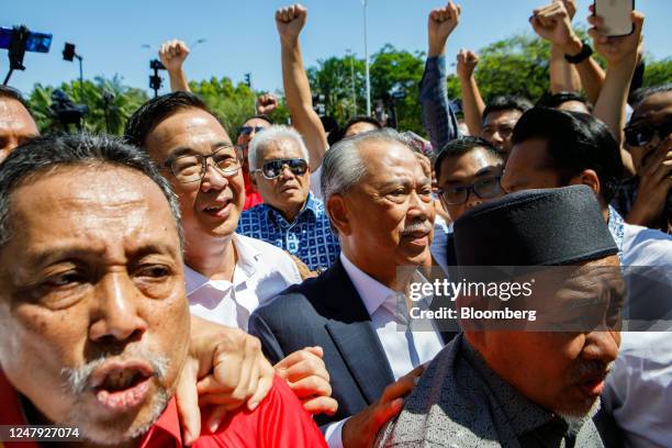 Muhyiddin Yassin, Malaysia's former prime minister, center right, arrives at the Malaysian Anti-Corruption Commission headquarters in Putrajaya,...