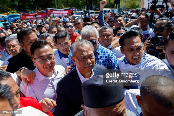 Muhyiddin Yassin, Malaysia's former prime minister, center right, arrives at the Malaysian Anti-Corruption Commission headquarters in Putrajaya,...