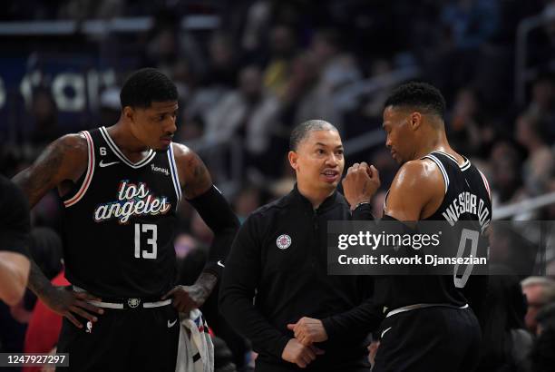 Head coach Tyrone Lue of the Los Angeles Clippers speaks with Russell Westbrook and Paul George of the Los Angeles Clippers during a break in the...