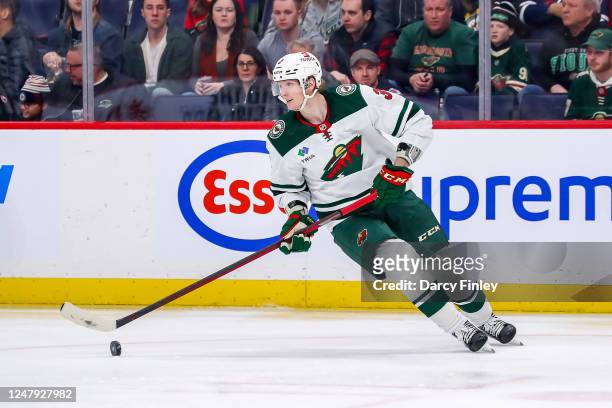 John Klingberg of the Minnesota Wild plays the puck during second period action against the Winnipeg Jets at the Canada Life Centre on March 8, 2023...