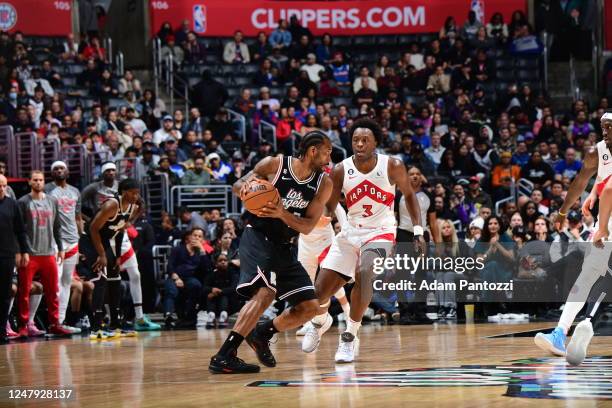 Kawhi Leonard of the LA Clippers handles the ball against defender OG Anunoby of the Toronto Raptors during the game on March 8, 2023 at Crypto.Com...