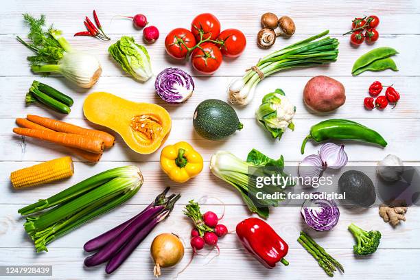 fresh organic vegetables shot from above on white table - vegetables white background stock pictures, royalty-free photos & images