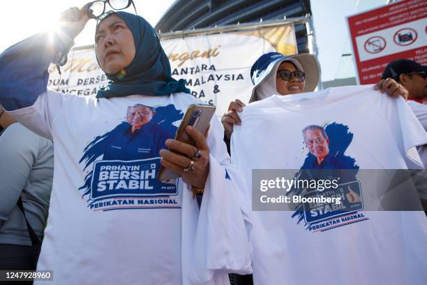 Supporters of Malaysia's former prime minister, Muhyiddin Yassin, not pictured, outside the Malaysian Anti-Corruption Commission headquarters in...